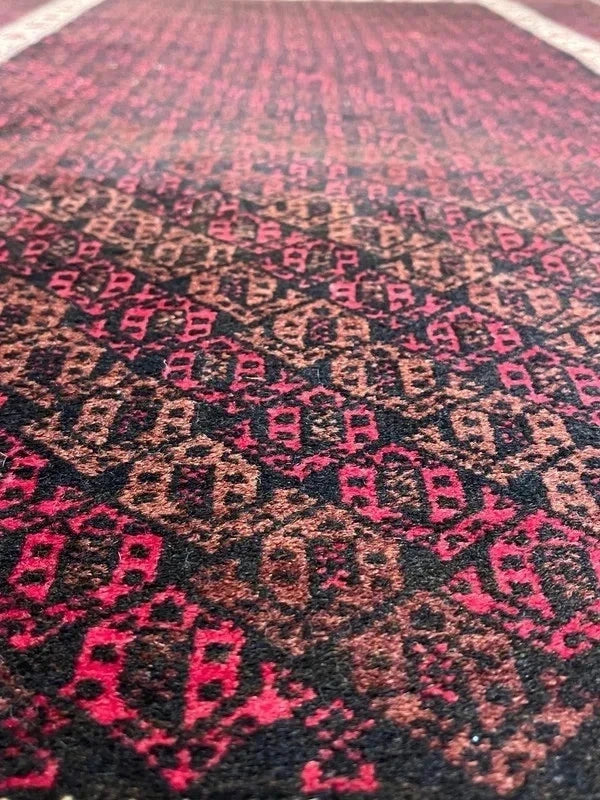 Handmade wool rug – Afghan/Baluch style – 180 × 102 cm – burgundy/black & ivory border — photograph 2