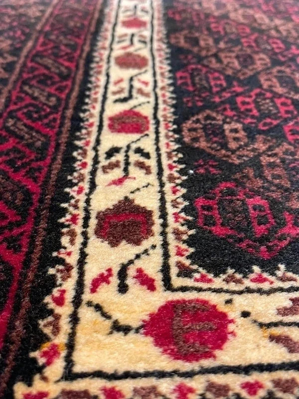 Handmade wool rug – Afghan/Baluch style – 180 × 102 cm – burgundy/black & ivory border — photograph 3