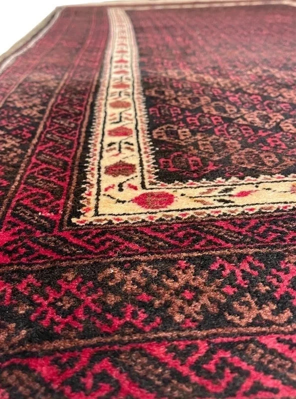 Handmade wool rug – Afghan/Baluch style – 180 × 102 cm – burgundy/black & ivory border — photograph 4